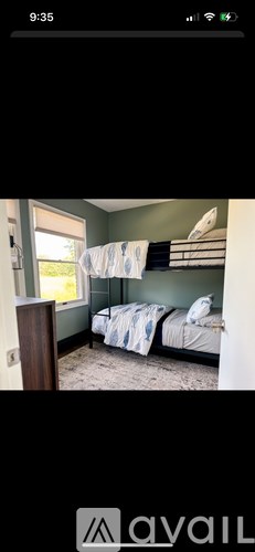 A room with two beds and a window.