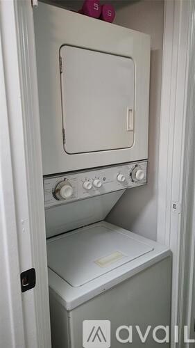 A white oven with a door open is in a kitchen.