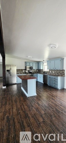 A kitchen with wooden floors and a countertop.