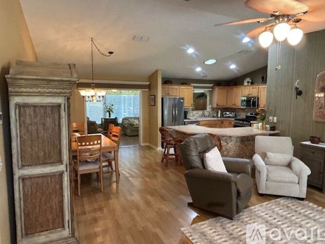 A living room with a dining table and chairs.