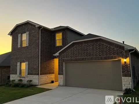 A house with a garage and a driveway in front.