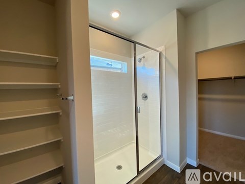 A glass door with a handle is in the middle of a room.