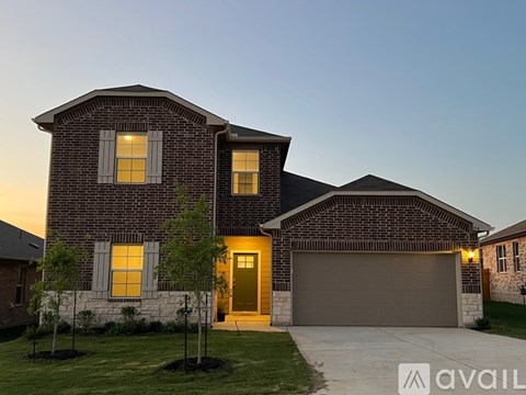 A house with a garage and a driveway is available for sale.