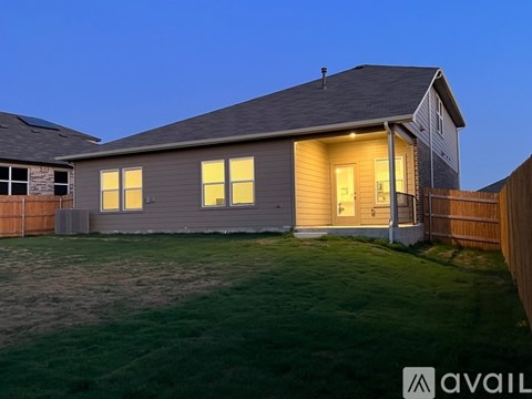 A house with a grey roof and a brown fence.