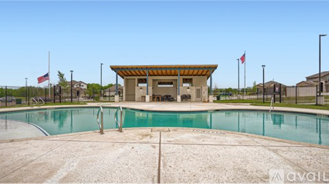 A pool with a building in the background.