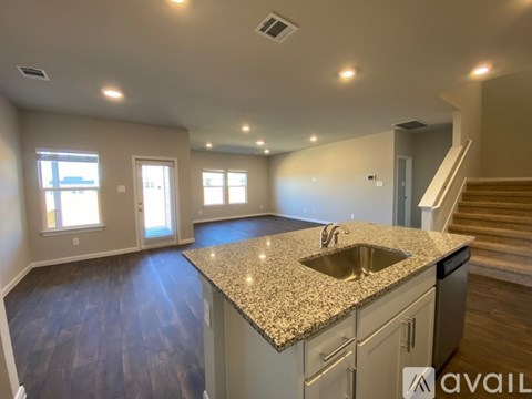 A kitchen with granite countertops and stainless steel appliances.