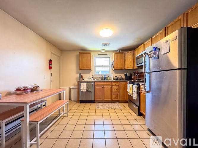A kitchen with a refrigerator, microwave, and oven.