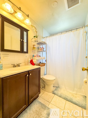 A bathroom with a white toilet and a white sink.