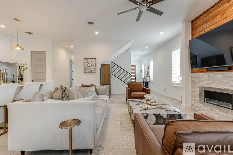A modern living room with a white sofa and a wooden coffee table.