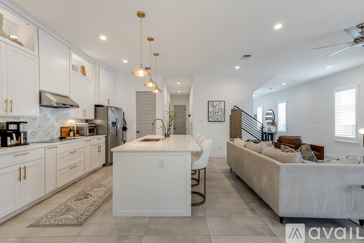 A modern kitchen with white cabinets and a large island.