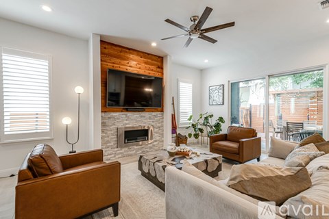 A living room with a fireplace and a television above it.