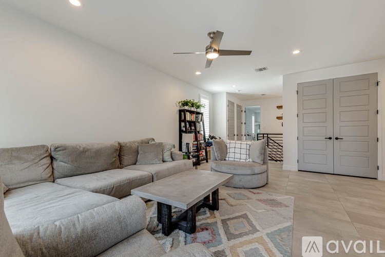 A living room with a grey sofa and a coffee table.