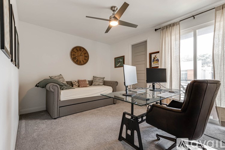 A modern living room with a brown leather chair and a glass coffee table.