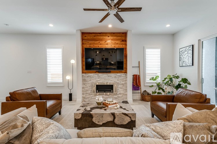 A living room with a fireplace and a TV above it.