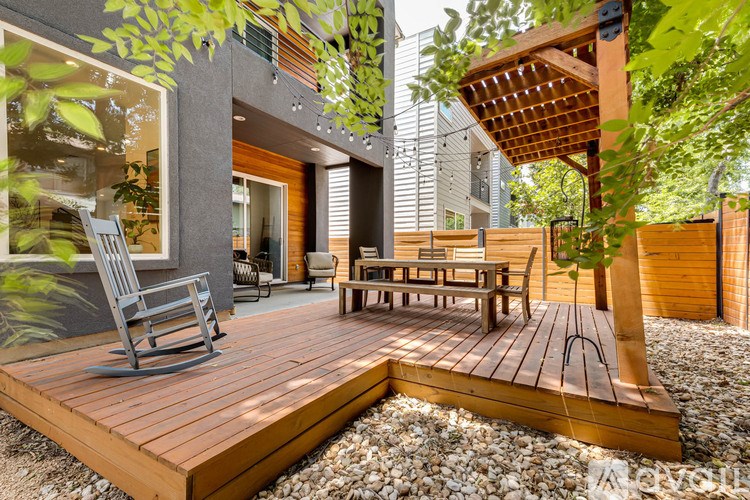 A wooden deck with a chair and table in the foreground.