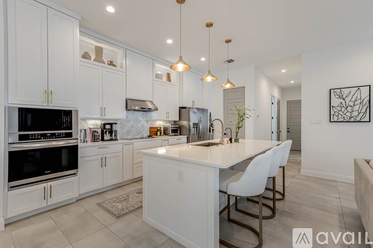 A modern kitchen with white cabinets and a central island.
