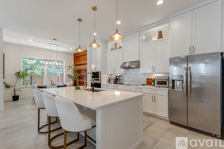 A modern kitchen with a large island and stainless steel appliances.