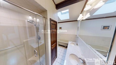 A bathroom with a walk-in shower and a toilet.