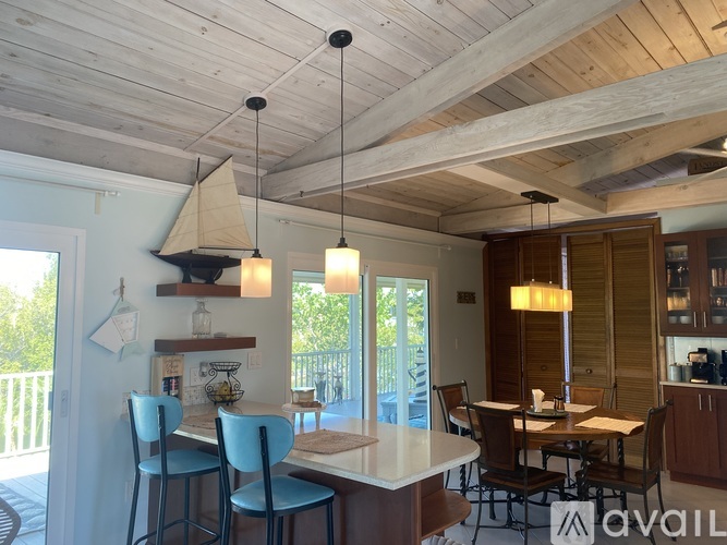A dining area with a table and chairs.