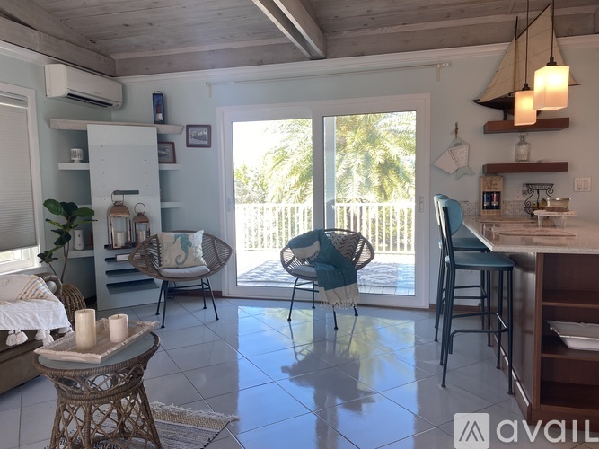 A living room with a dining table and chairs.
