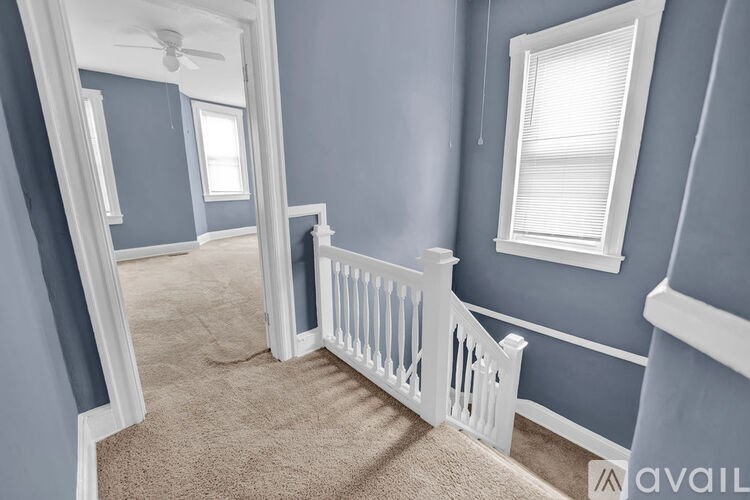 A room with blue walls and a white railing.