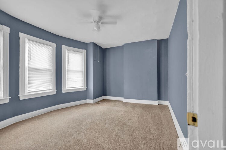 A room with blue walls and a carpeted floor.