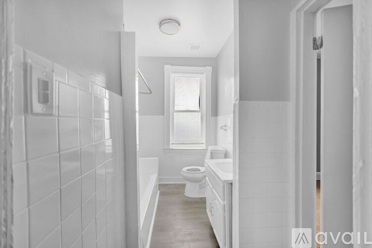 A bathroom with a toilet, sink, and bathtub.