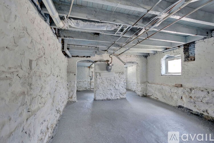 A room with white walls and a concrete floor is available for rent.