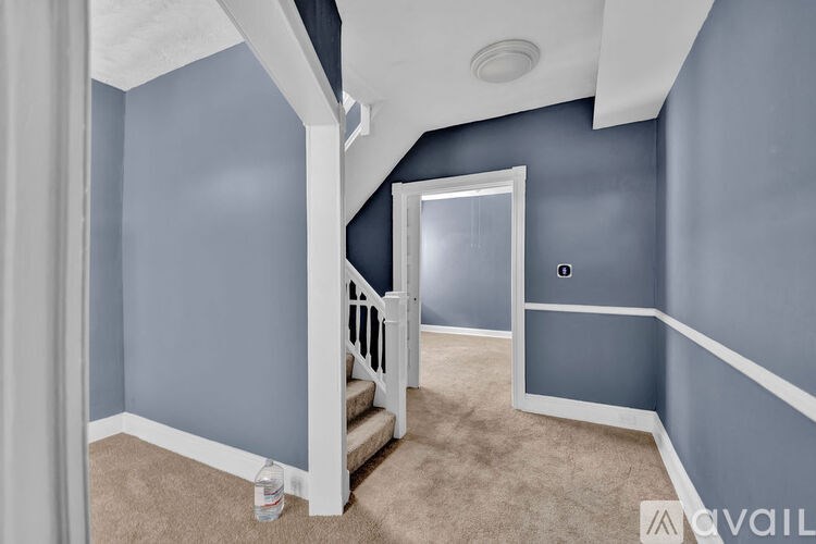 A room with blue walls and a carpeted floor.