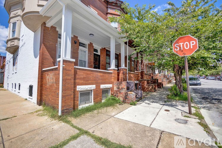 A stop sign is in front of a brick building.