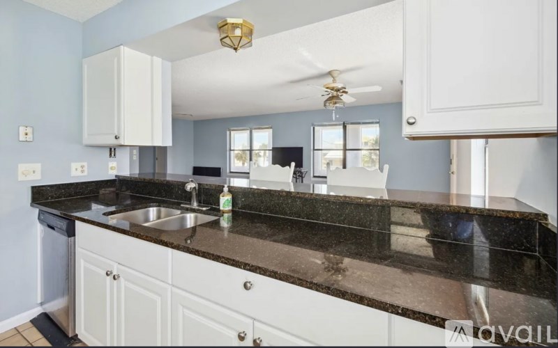 A kitchen with a sink and a counter.