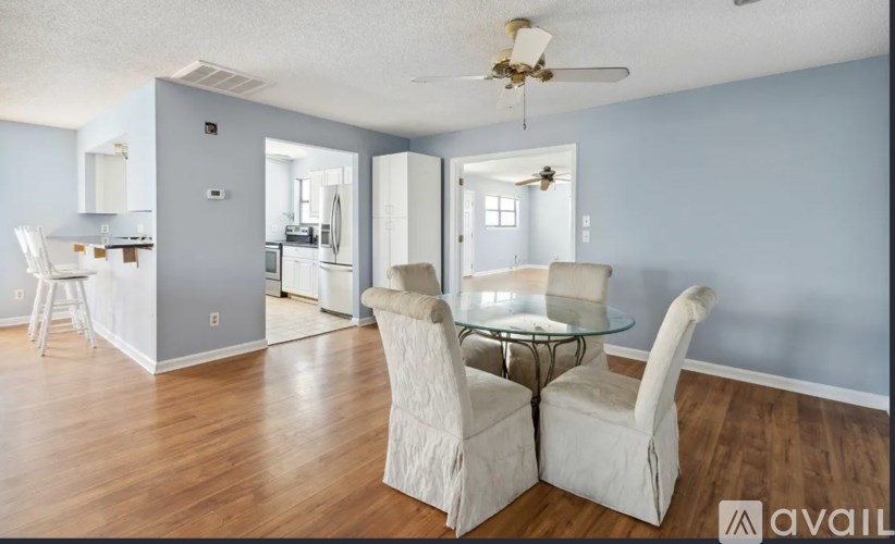 A dining room with a glass table and chairs.