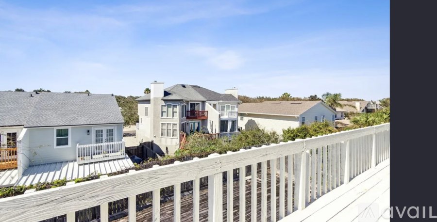 A row of houses with a wooden fence in front.