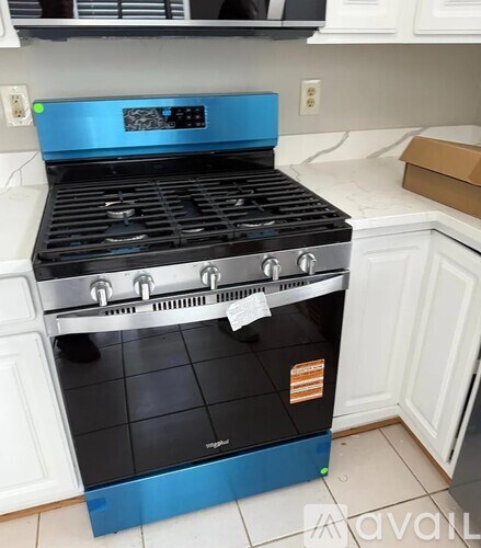 A blue and black stove top oven in a kitchen.