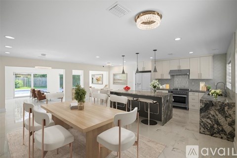A modern kitchen with a dining table and chairs.