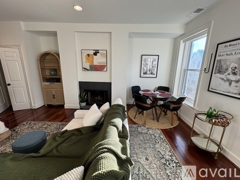 A room with a fireplace and wooden floors.
