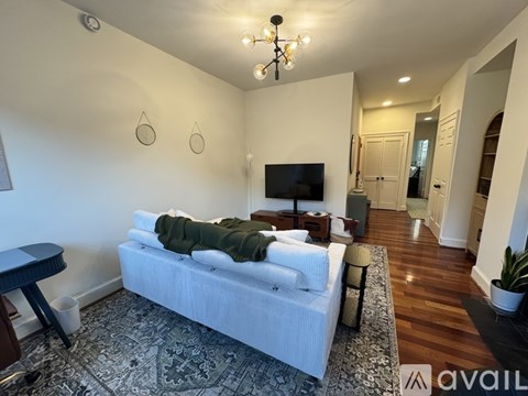 A living room with a fireplace and hardwood floors.