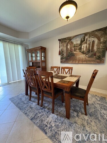 A dining room with a table set for four.