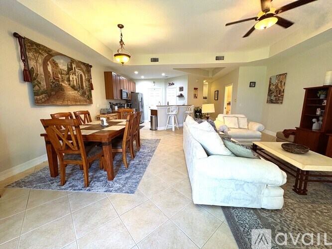 A living room with a dining table and chairs.