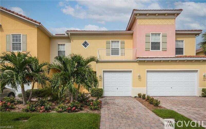 A two-story house with a pink accent wall and a white garage door.