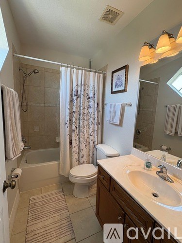 A bathroom with a toilet, sink, and shower.