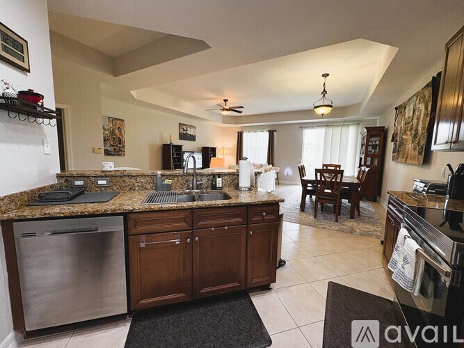 A kitchen with a granite countertop and stainless steel appliances.