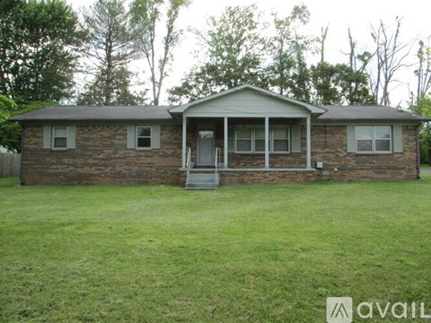 A brick house with a porch and a covered entrance.