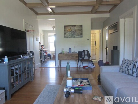 A living room with a grey couch and a wooden coffee table.