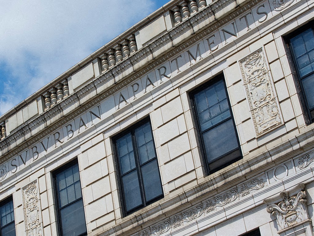 the side of a building with windows and a sign on it