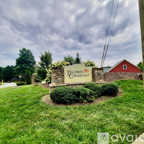 A sign for Palmview Commons stands in a grassy area.