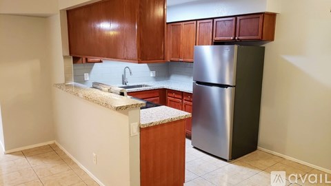 A kitchen with a granite countertop and stainless steel appliances.