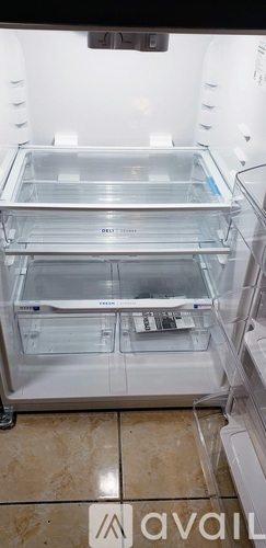 Empty white refrigerator with a glass door.