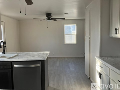 A kitchen with a dishwasher and a ceiling fan.
