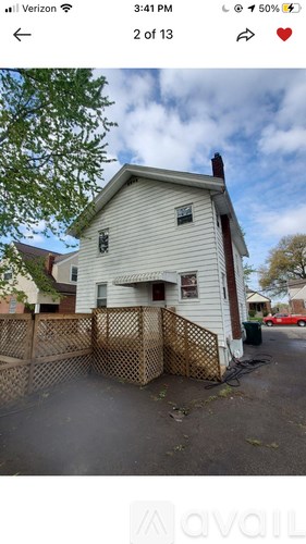 A house with a white exterior and a brown fence.